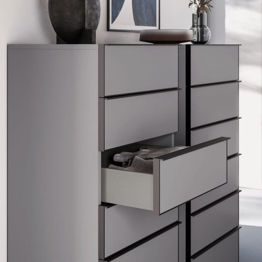 Gray dresser with open drawer against a white wall