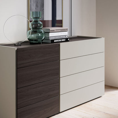 Modern dresser with wooden and white drawers in a minimalistic room.
