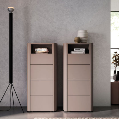 Two tall, narrow storage units against a gray wall with books and decorative items on top.