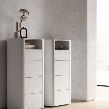 Two white dressers with drawers against a gray wall.