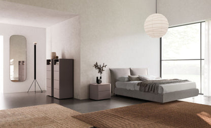 Modern bedroom with a bed, nightstands, and a dresser.