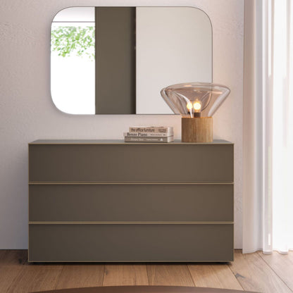 Gray dresser with a mirror and decorative items in a room setting