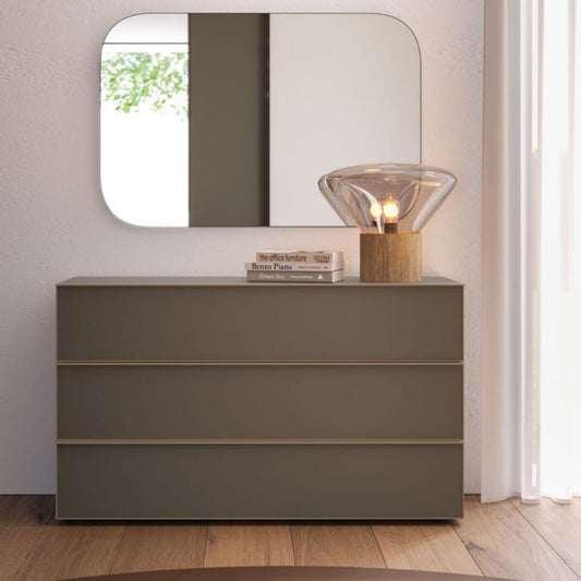 Gray dresser with a mirror and decorative items in a room setting
