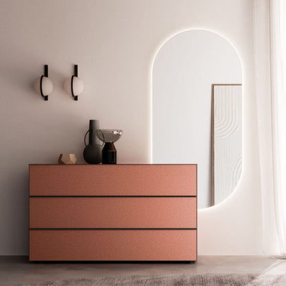 Modern dresser with a textured finish in a minimalistic room.