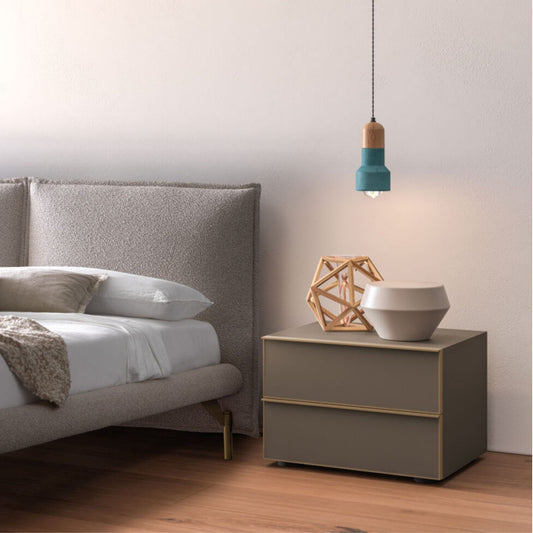 Modern bedroom with a bed and nightstand featuring decorative items.