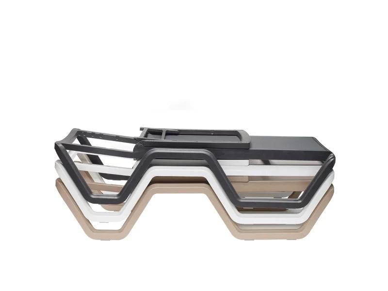Stacked outdoor sun loungers in black, taupe, and white finishes demonstrating the space-saving stackable design.