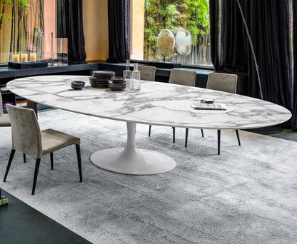 Oval marble dining table Saarinen style with white pedestal base in a modern Italian living room, seating six people