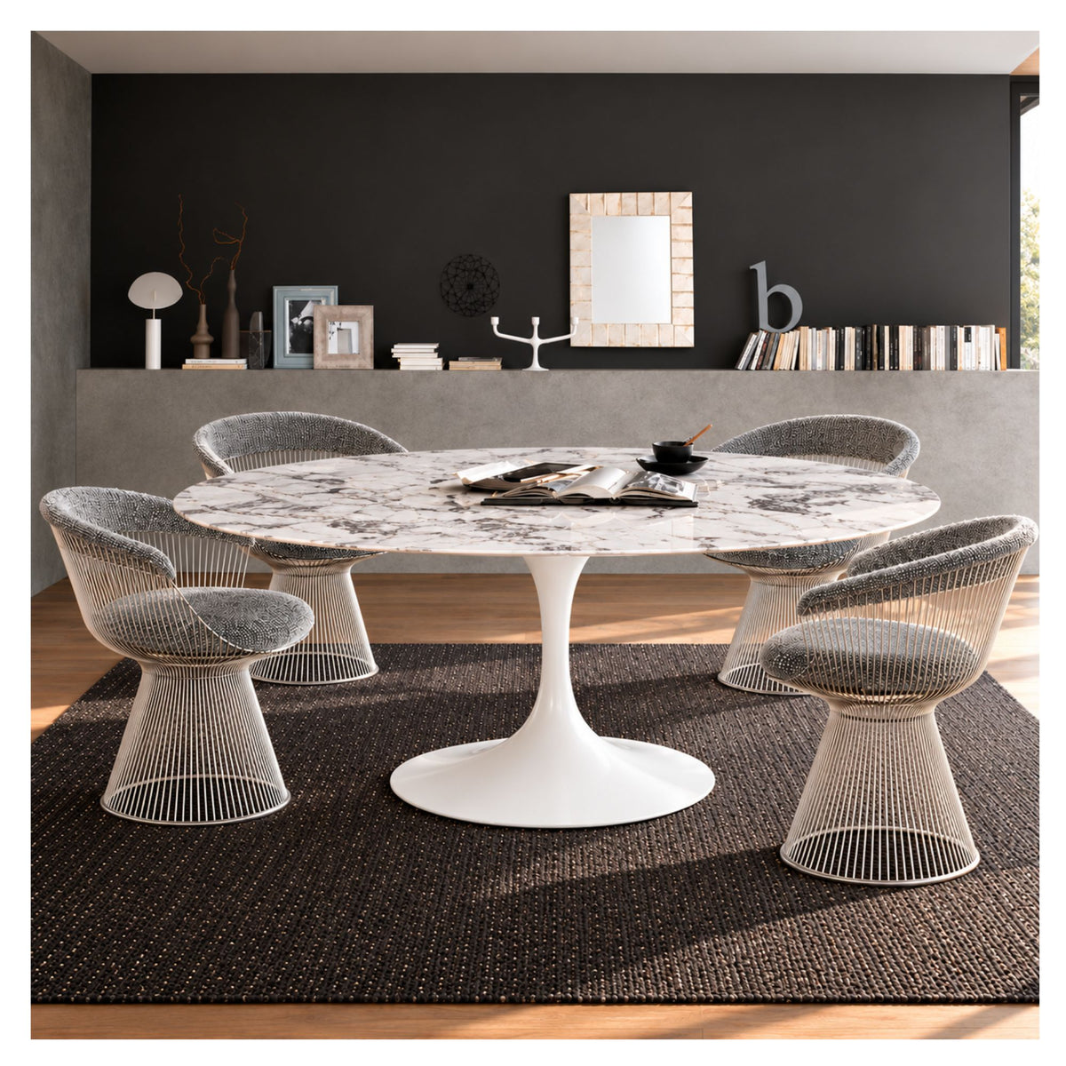 Oval Tulip dining table with a grey veined ceramic top and white pedestal base, surrounded by four upholstered wire chairs