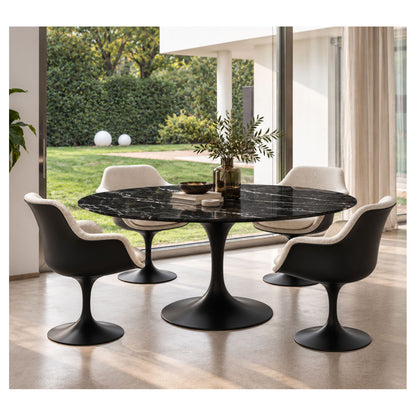 Oval Tulip dining table with a black veined ceramic top and black pedestal base, surrounded by four upholstered chairs.