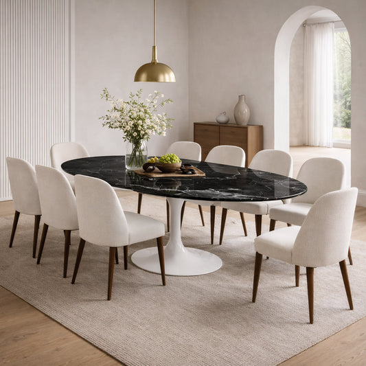 Oval tulip dining table with Marquinia ceramic black top and black pedestal base in a modern dining room setting