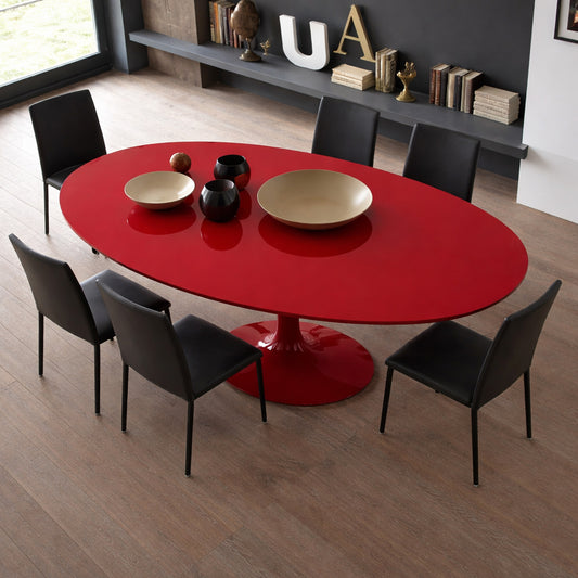 Oval tulip dining table with red laminate top and matching red pedestal base, styled with black chairs in a modern dining room