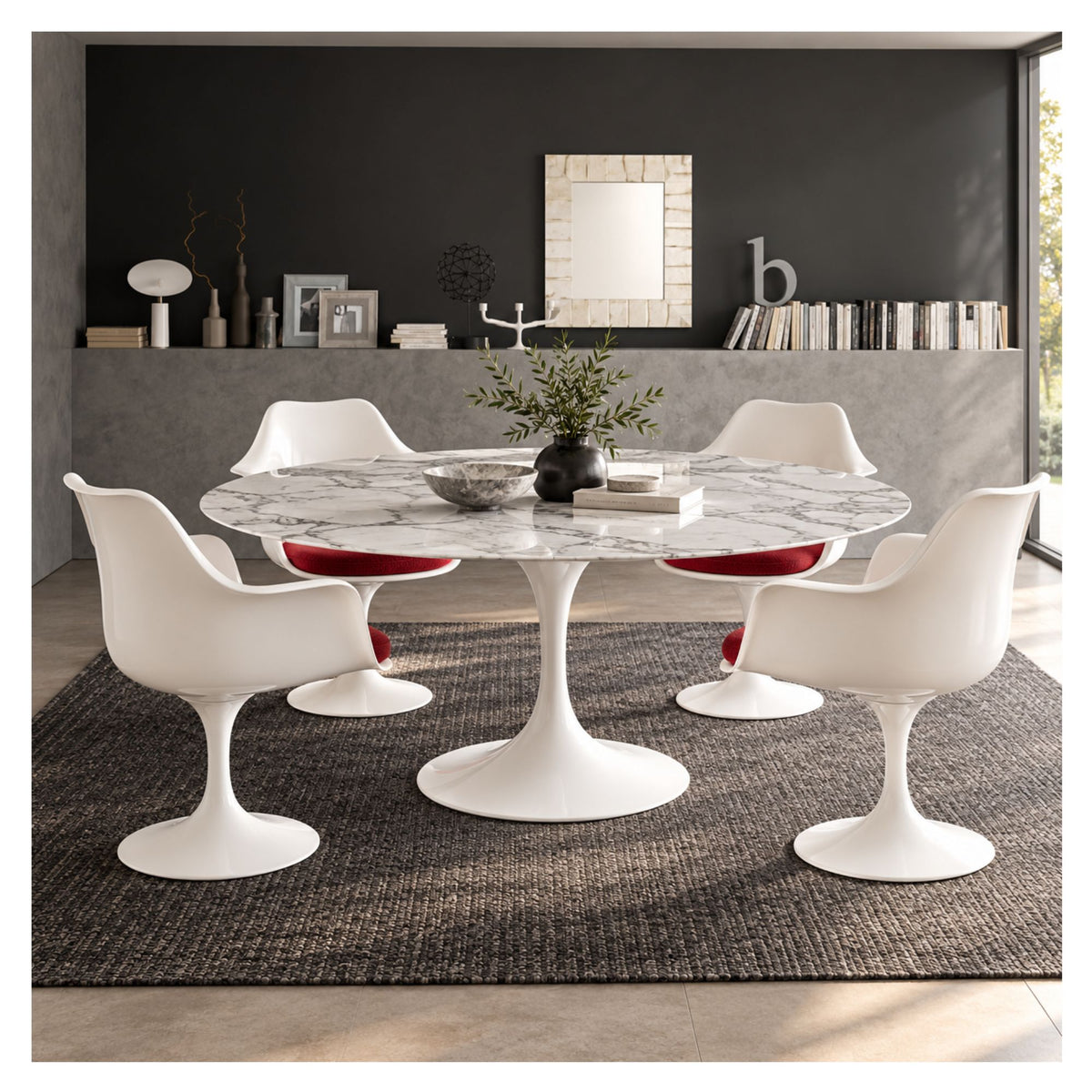 Oval white marble Tulip dining table with a white pedestal base, surrounded by four white chairs with red cushions in a modern dining room.