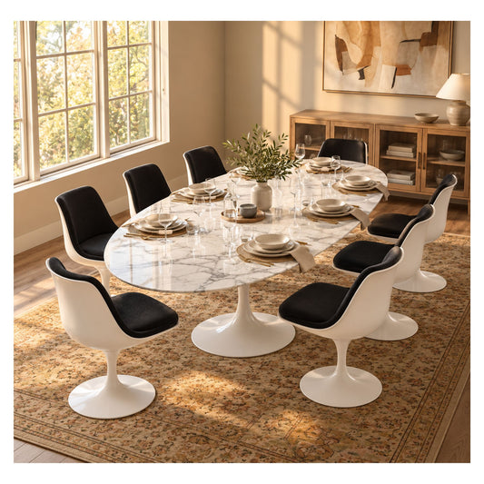 Oval Tulip executive table with a white veined marble top and pedestal base, surrounded by white chairs with black seats in a bright meeting room.