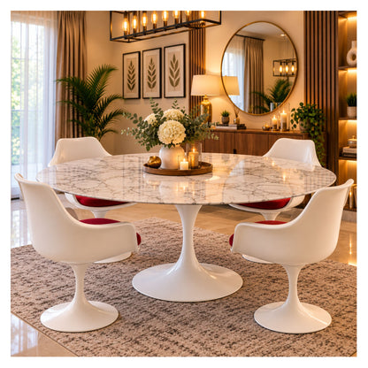 Oval white marble Tulip dining table with a white pedestal base and four white chairs with red seats, styled in a warm, elegant dining room