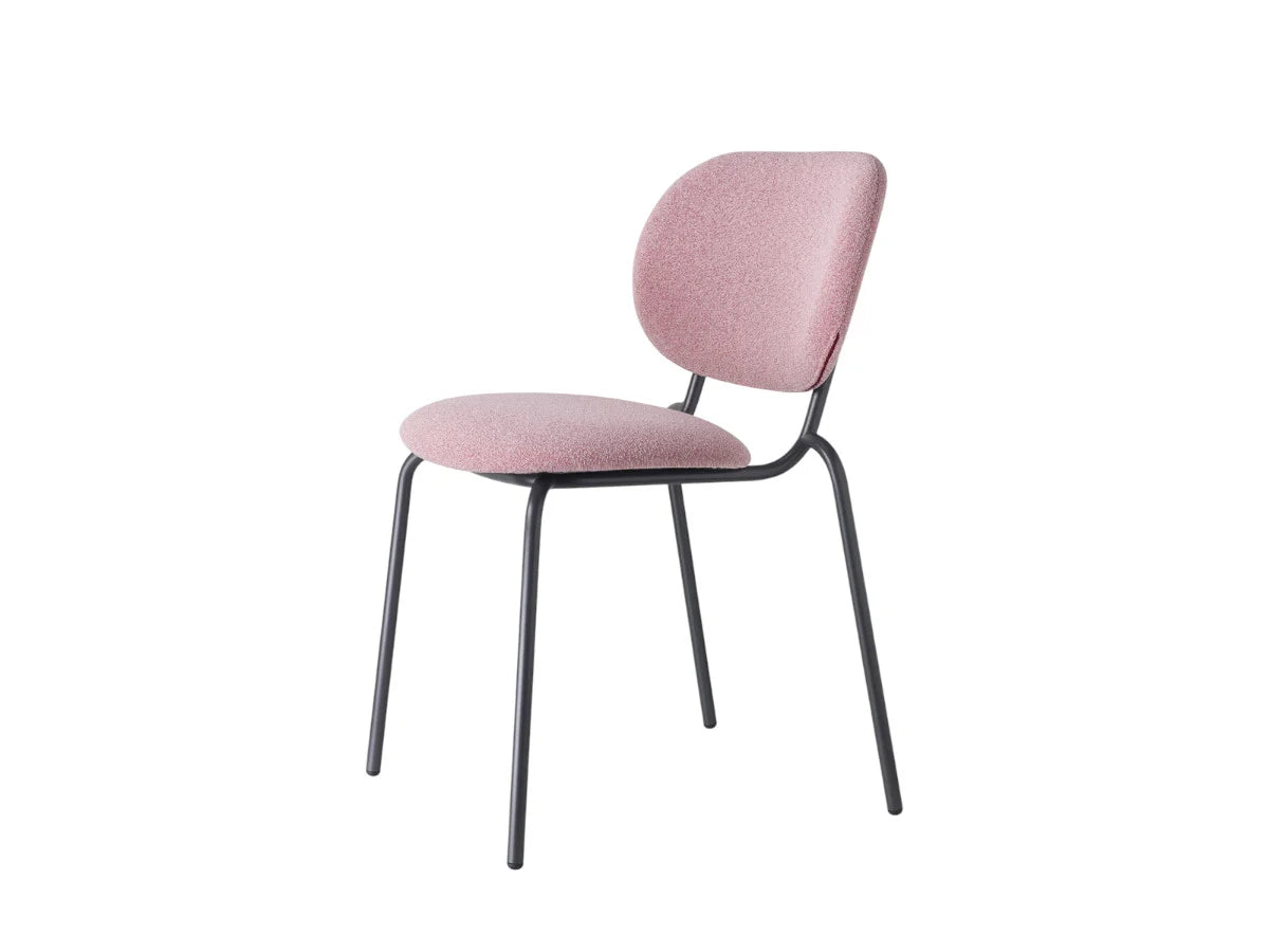 Front angled view of a pink upholstered dining chair with a rounded backrest, padded seat, and slim dark metal frame.