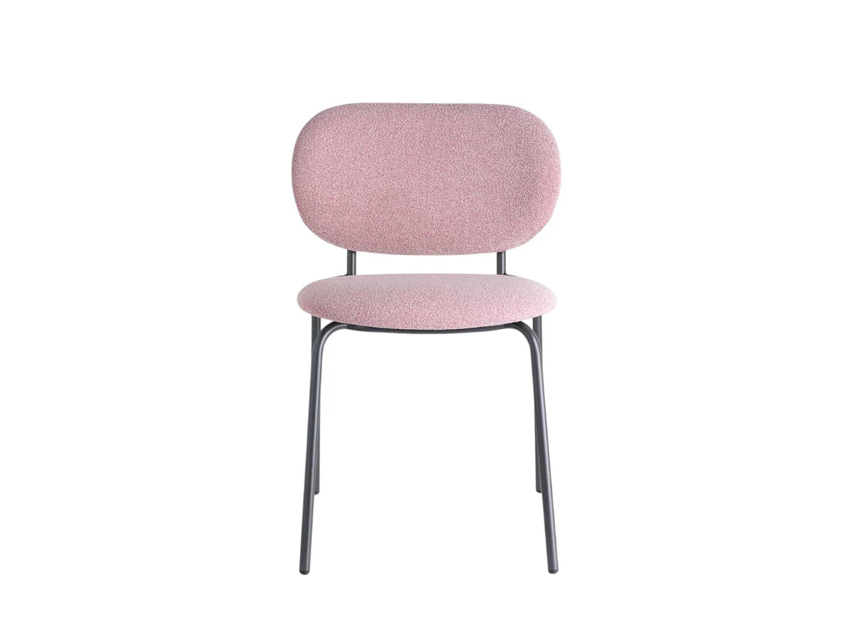 Modern pink upholstered dining chair with rounded backrest, padded seat, and slim dark metal legs on a white background.