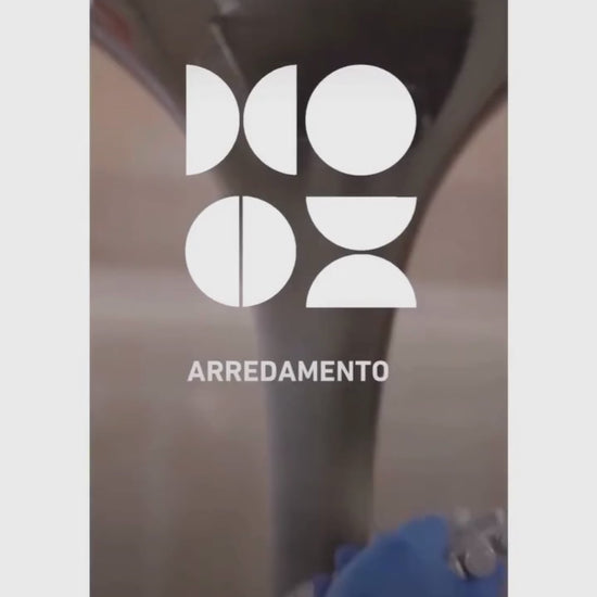 Oval tulip dining table in a warm modern Italian dining room setting with minimalist interior styling and neutral tones