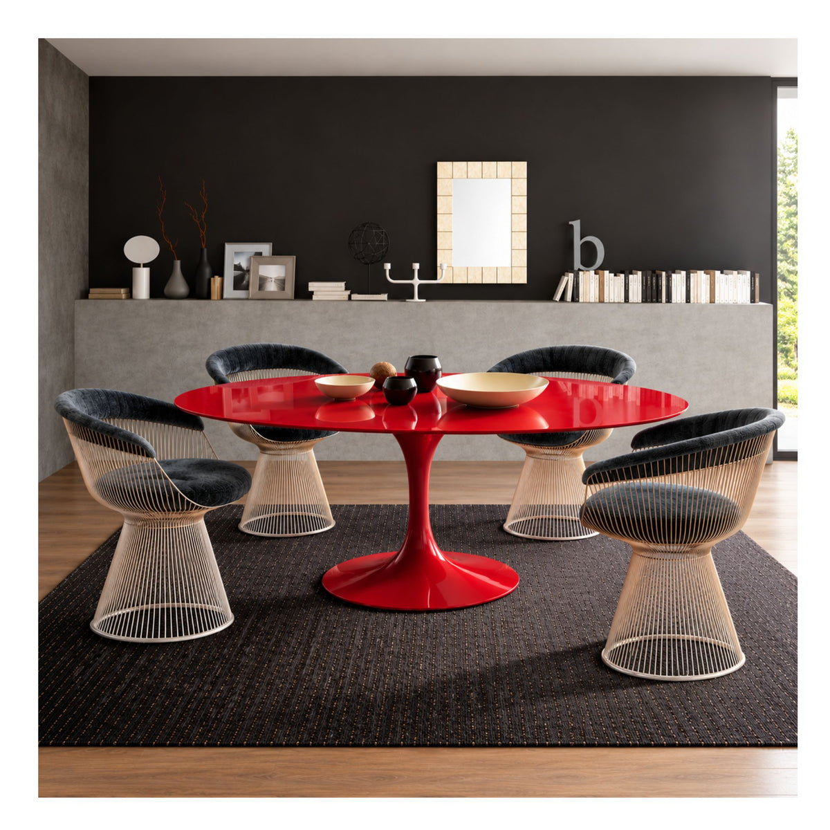 Red round Tulip dining table paired with four Bertoia dining chairs in a modern dining room, featuring a glossy pedestal base and contemporary wire-frame seating.