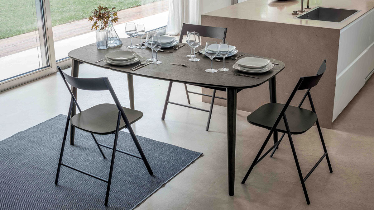 Ribot Wood extendable dining table by Altacom with dark oak wood top, stained ash legs and internal folding extension in a modern kitchen