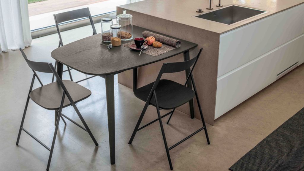 Ribot Wood compact extendable dining table by Altacom with dark oak finish and stained ash legs for modern kitchens