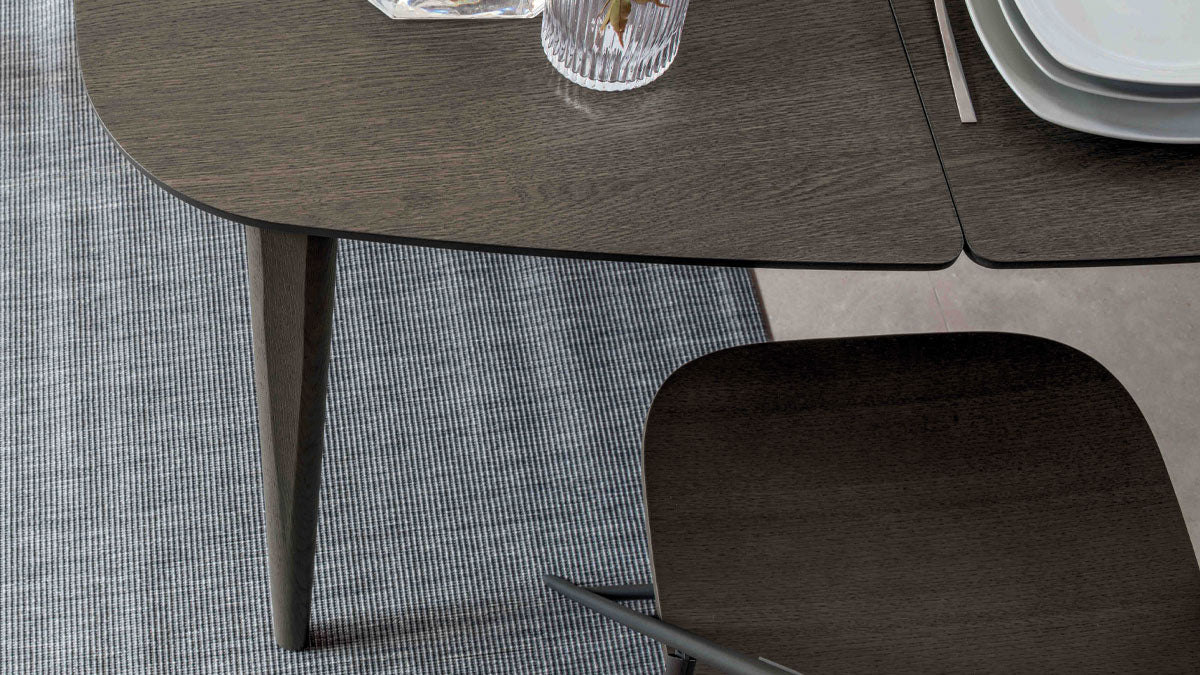 Close-up of Ribot Wood dining table by Altacom featuring a dark oak wood tabletop with rounded corners