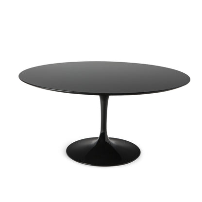 Round black tulip dining table with pedestal base isolated on a white background with clean minimalist design