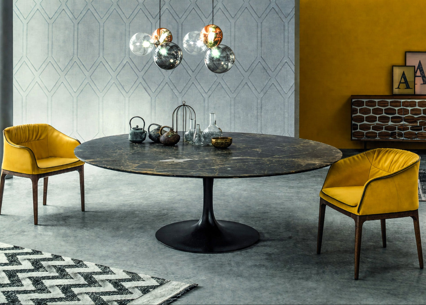 Round dark marble dining table with black pedestal base in a modern interior Saarinen style, styled with mustard upholstered chairs, geometric wall paneling and glass globe pendant lighting