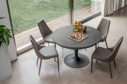 Round pedestal dining table with marble effect top and black base seating four