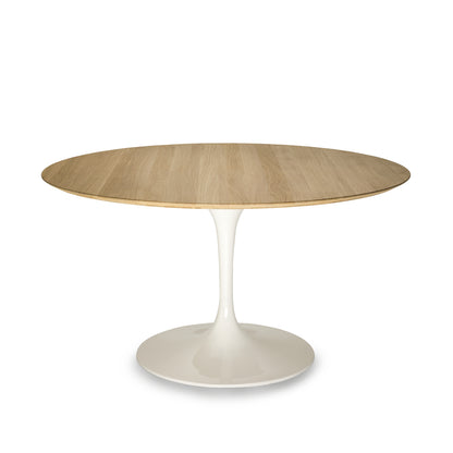 Round oak tulip dining table with natural wood top and white pedestal base isolated on a clean white background

