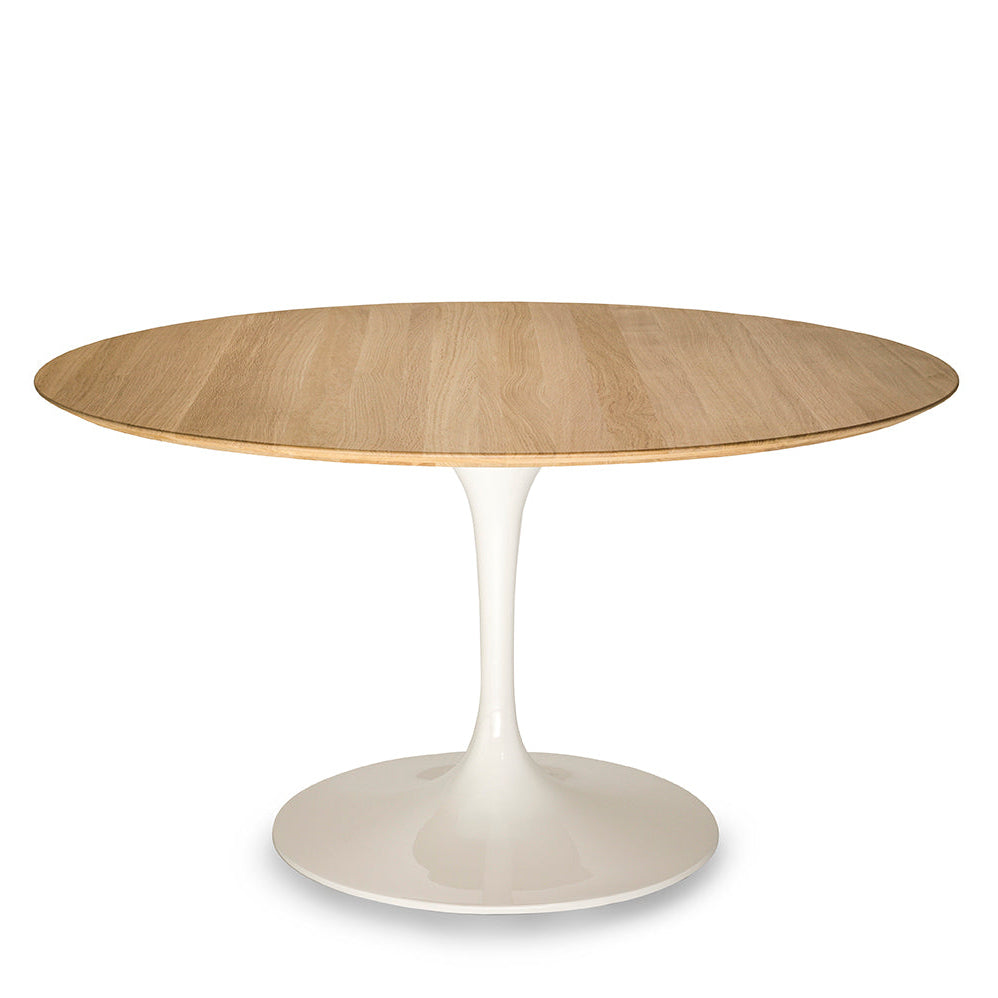 Round oak tulip dining table with natural wood top and white pedestal base isolated on a white background
