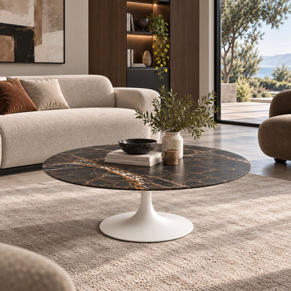Round & oval Tulip coffee table with a black Marquina marble-effect ceramic top and white pedestal base styled in a contemporary living room