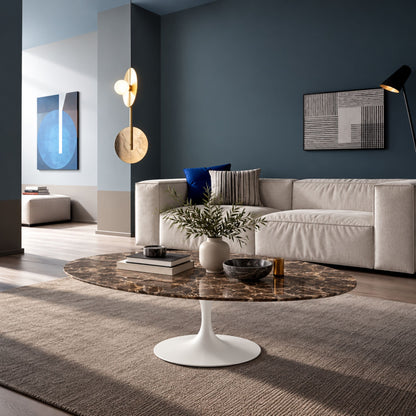 Round tulip coffee table with a dark marble-effect top and white pedestal base in a modern living room with contemporary décor.