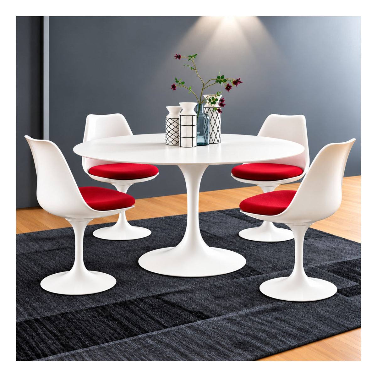Round Tulip dining table with a white top and pedestal base, surrounded by four white chairs with red seat cushions
