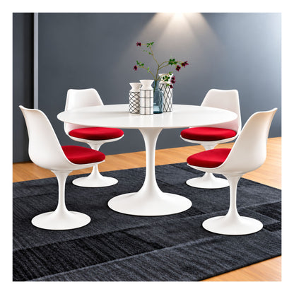 Round Tulip dining table with a white top and pedestal base, surrounded by four white chairs with red seat cushions