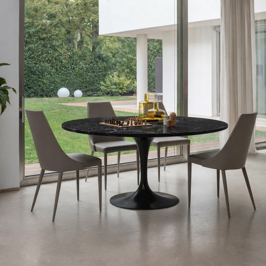 Round tulip table Saarinen style with black marble top in modern dining room