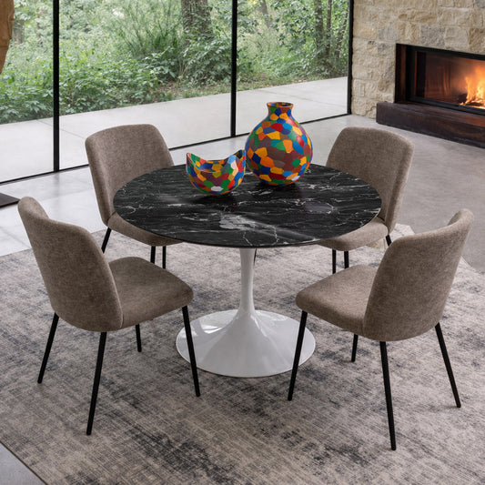 Round tulip table Saarinen style with black marble top and white pedestal base in modern dining room