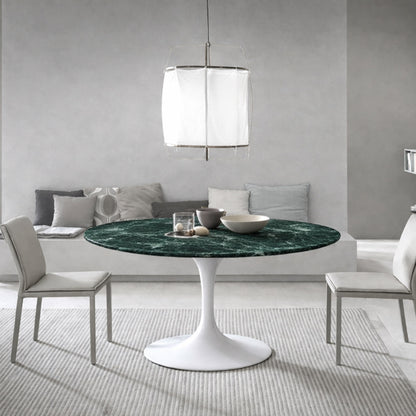 Round tulip table Saarinen style with Guatemala green marble top and white pedestal base in modern dining room