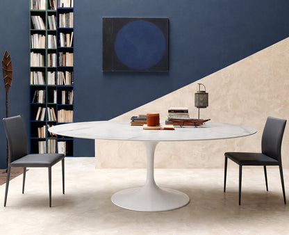 Round tulip table Saarinen style with white marble top in modern dining room with blue wall
