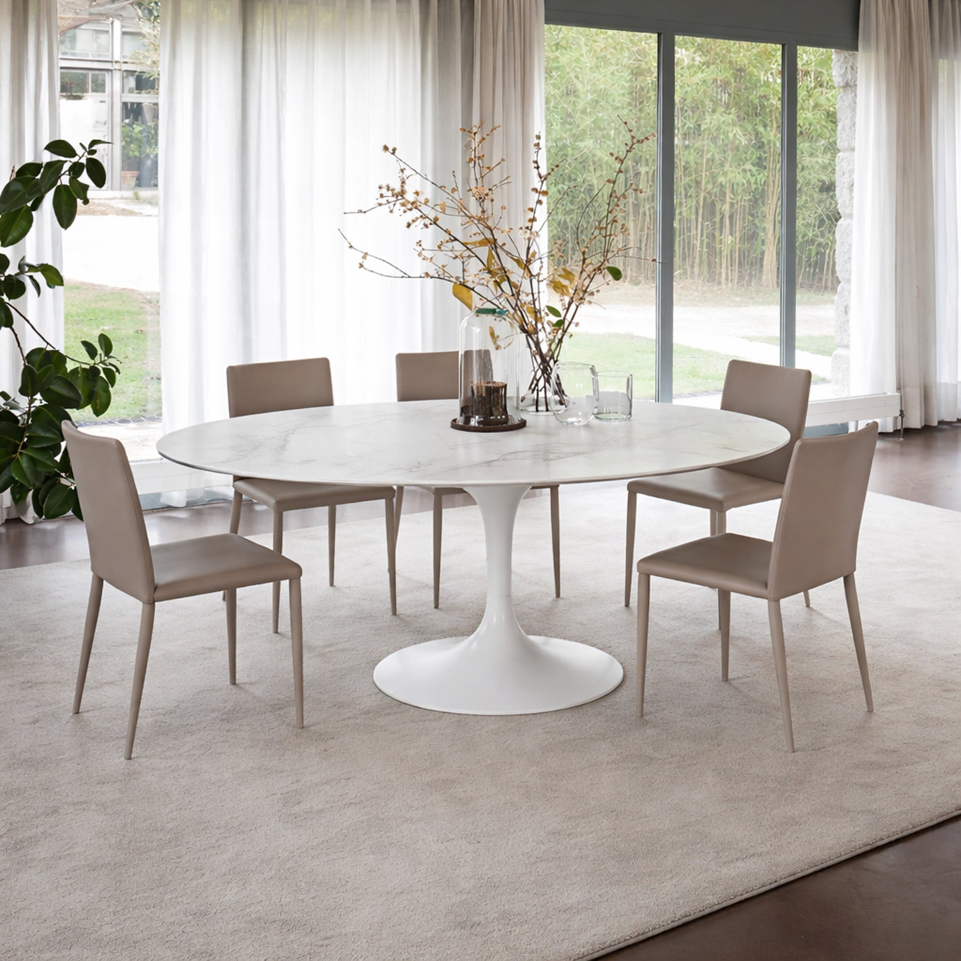 Round tulip table Saarinen style with white marble top in bright modern dining room