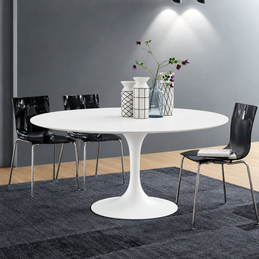 Round white marble dining table with white pedestal base in a modern dark interior, styled with black chairs, grey wall and wall-mounted lighting