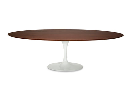 Saarinen-style oval tulip dining table with walnut-effect top and white pedestal base on a clean white background