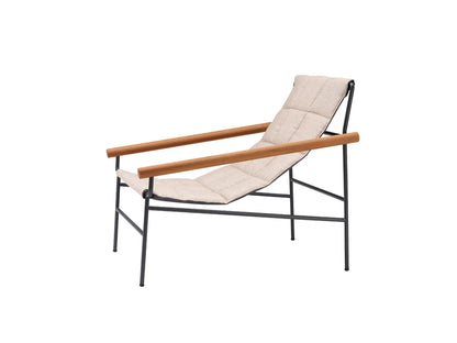 S•CAB Dress Code Glam outdoor armchair featuring quilted water-repellent fabric, iroko wood armrests and a powder-coated steel frame for premium garden and patio seating