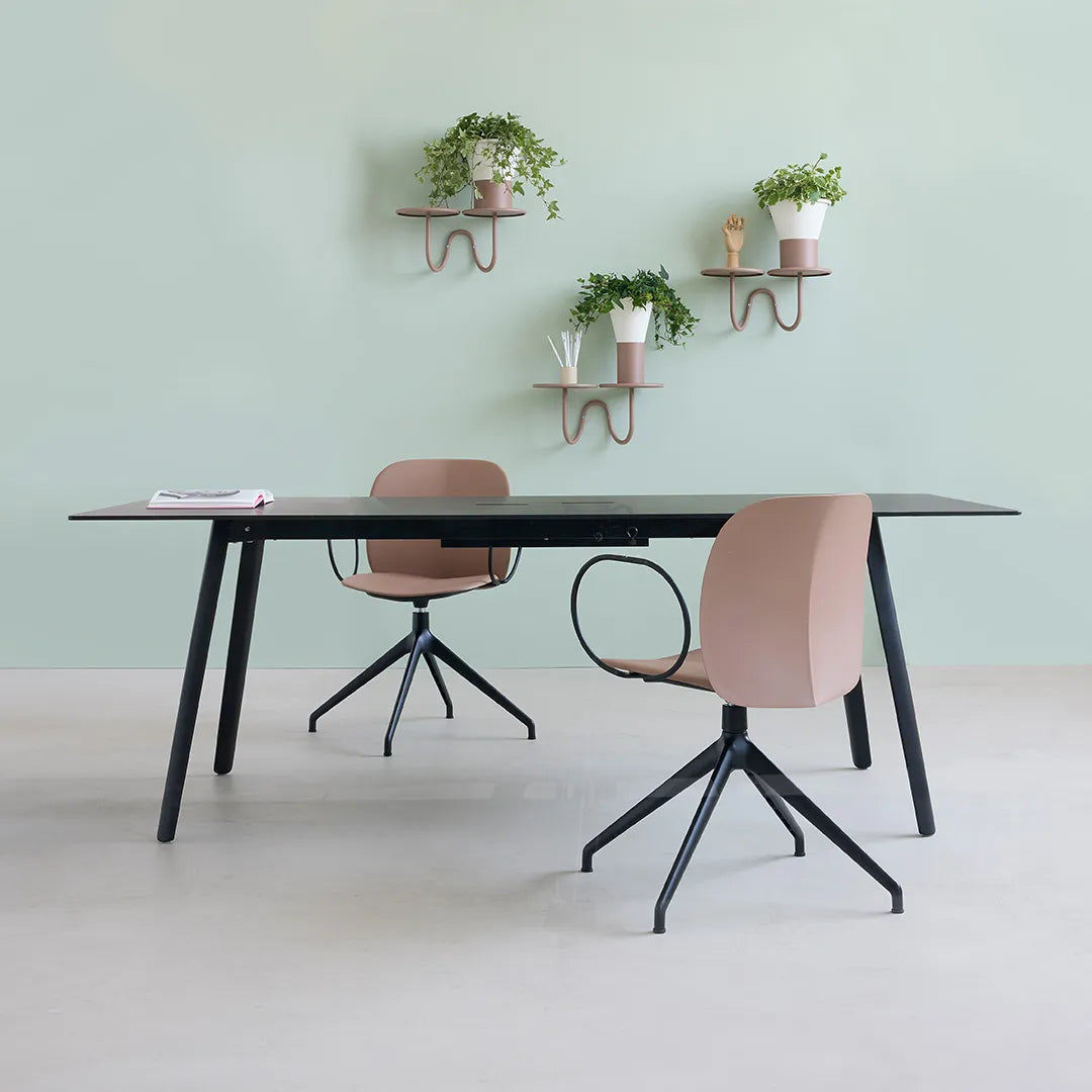 S•CAB Squid OF Office Meeting Table with a black tabletop and angled legs in a contemporary office meeting space paired with swivel office chairs.