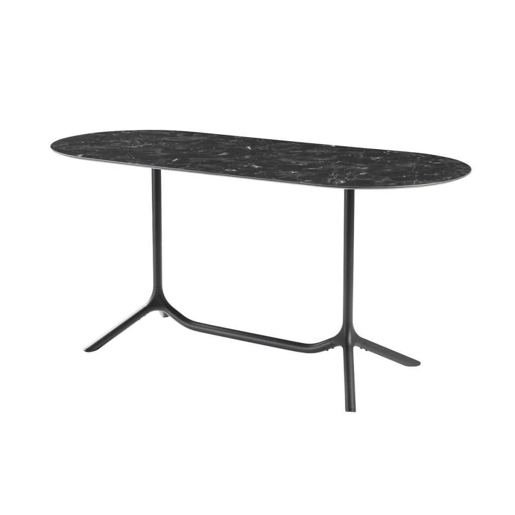 Front angled view of the S•CAB Tripé Double Dining Table Base with a black marble-effect oval tabletop and elegant double pedestal metal base.