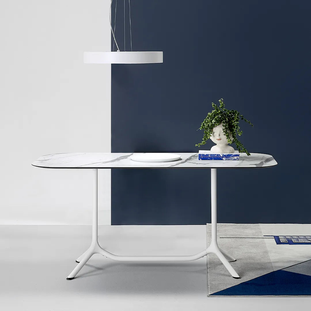 S•CAB Tripé Double Dining Table Base with a white marble-effect oval tabletop in a contemporary indoor dining setting.