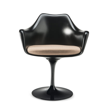 Tulip armchair with a black moulded fibreglass shell, black cast aluminium pedestal base and beige upholstered seat cushion, inspired by Eero Saarinen's iconic mid-century modern Pedestal Collection for contemporary dining spaces.