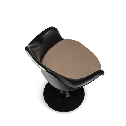 Top angled view of a Tulip armchair with a black moulded fibreglass shell, beige upholstered seat cushion and black cast aluminium pedestal base, inspired by Eero Saarinen's iconic mid-century modern Pedestal Collection
