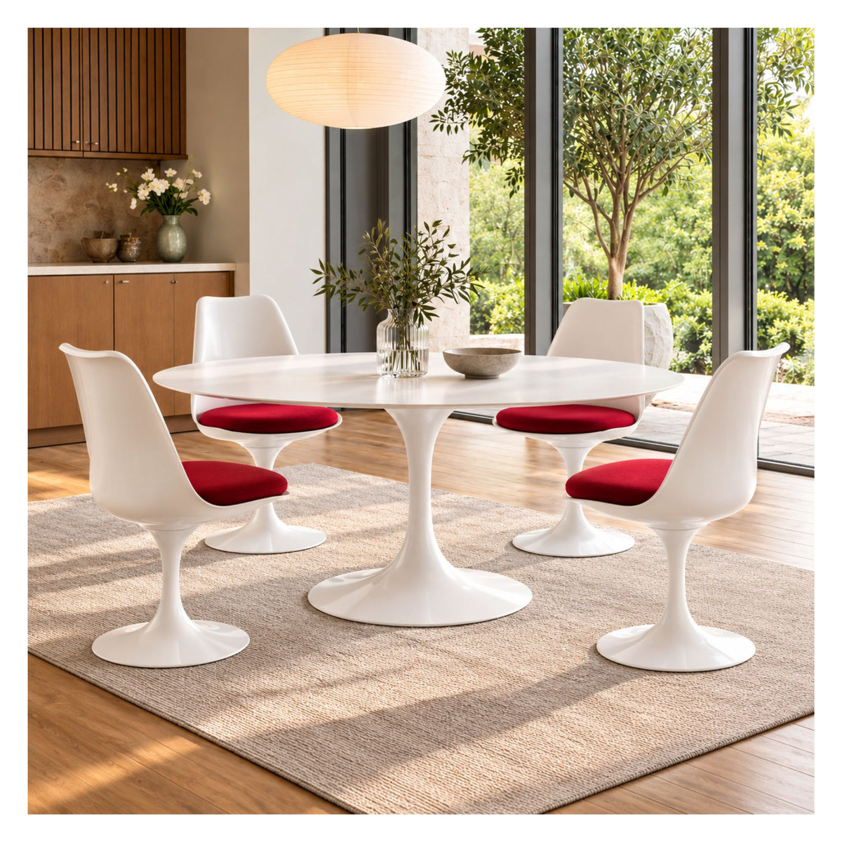 White Tulip dining table with round top and four white Tulip dining chairs featuring red upholstered seats in a modern dining room