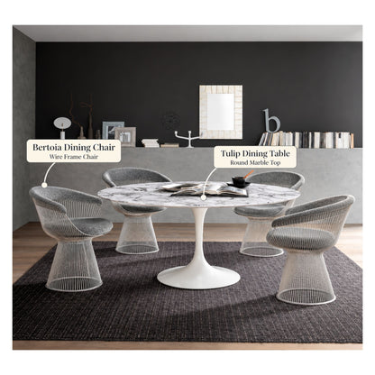 Modern dining room featuring a white round Tulip dining table with a marble top surrounded by four Bertoia wire frame dining chairs in silver, showcasing timeless mid-century modern furniture.