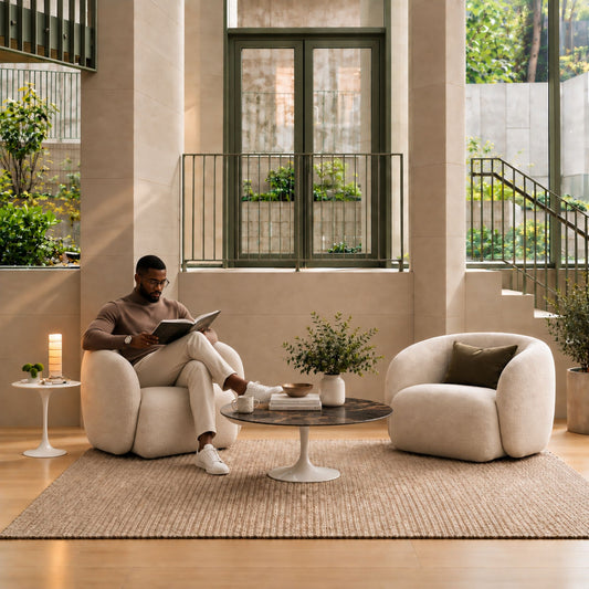 Verde Serenity Tulip coffee table featuring a polished Verde Alpi marble tabletop with rich green tones and natural white veining, paired with a glossy white tulip pedestal base, styled in a luxury contemporary living room with sculptural lounge chairs, warm natural light, and elegant modern décor. An Italian designer coffee table for sophisticated residential interiors.